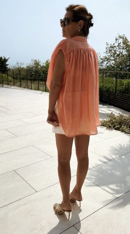 Blouse fluide corail avec broderies dorées, une pièce lumineuse et élégante parfaite pour les beaux jours.