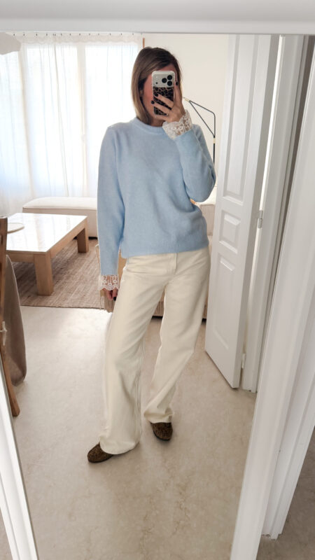 Pull bleu ciel en maille douce avec poignets en dentelle, porté avec un pantalon clair