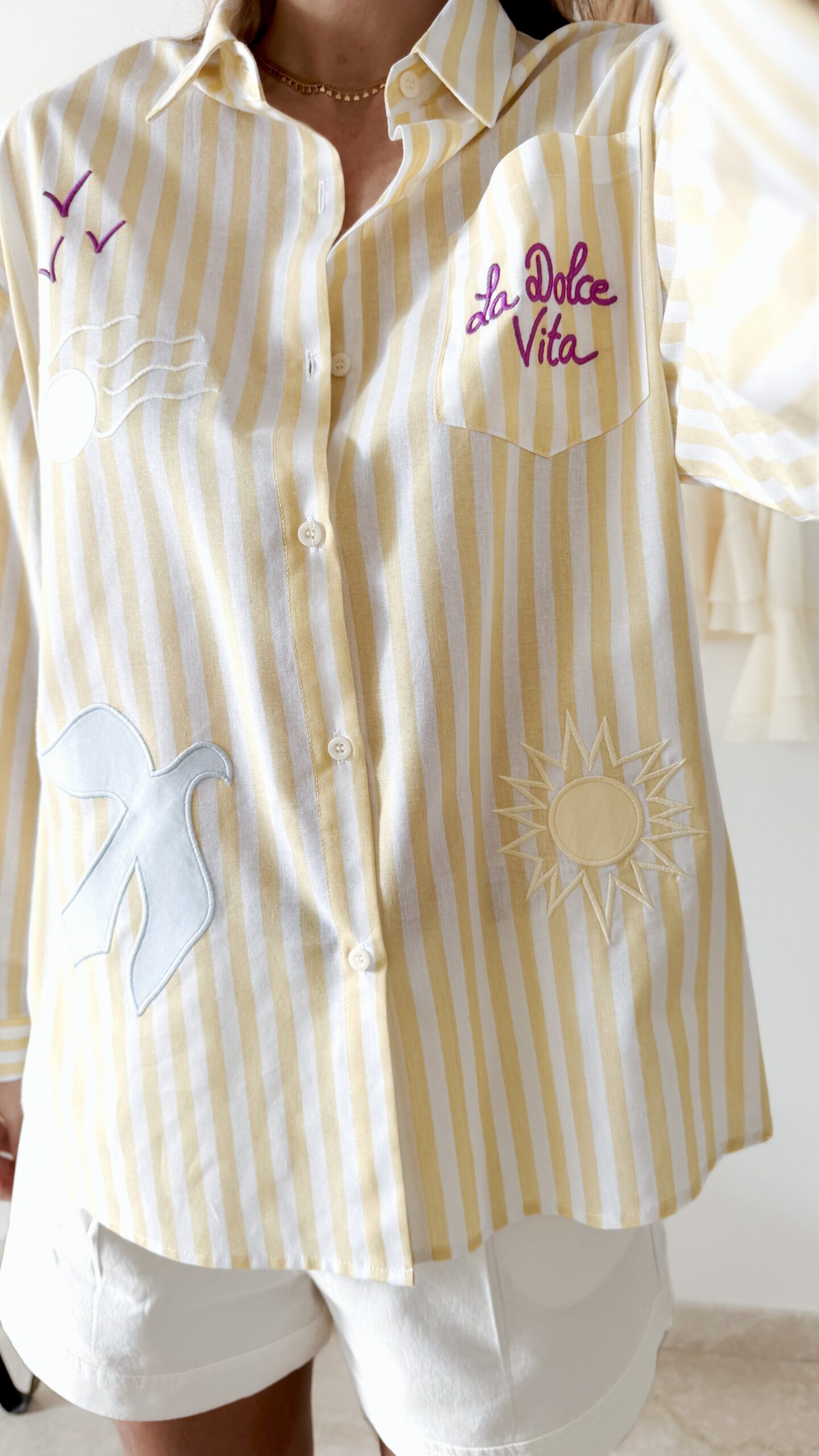 Chemise femme rayée jaune et blanche avec broderies estivales et inscription "La Dolce Vita"