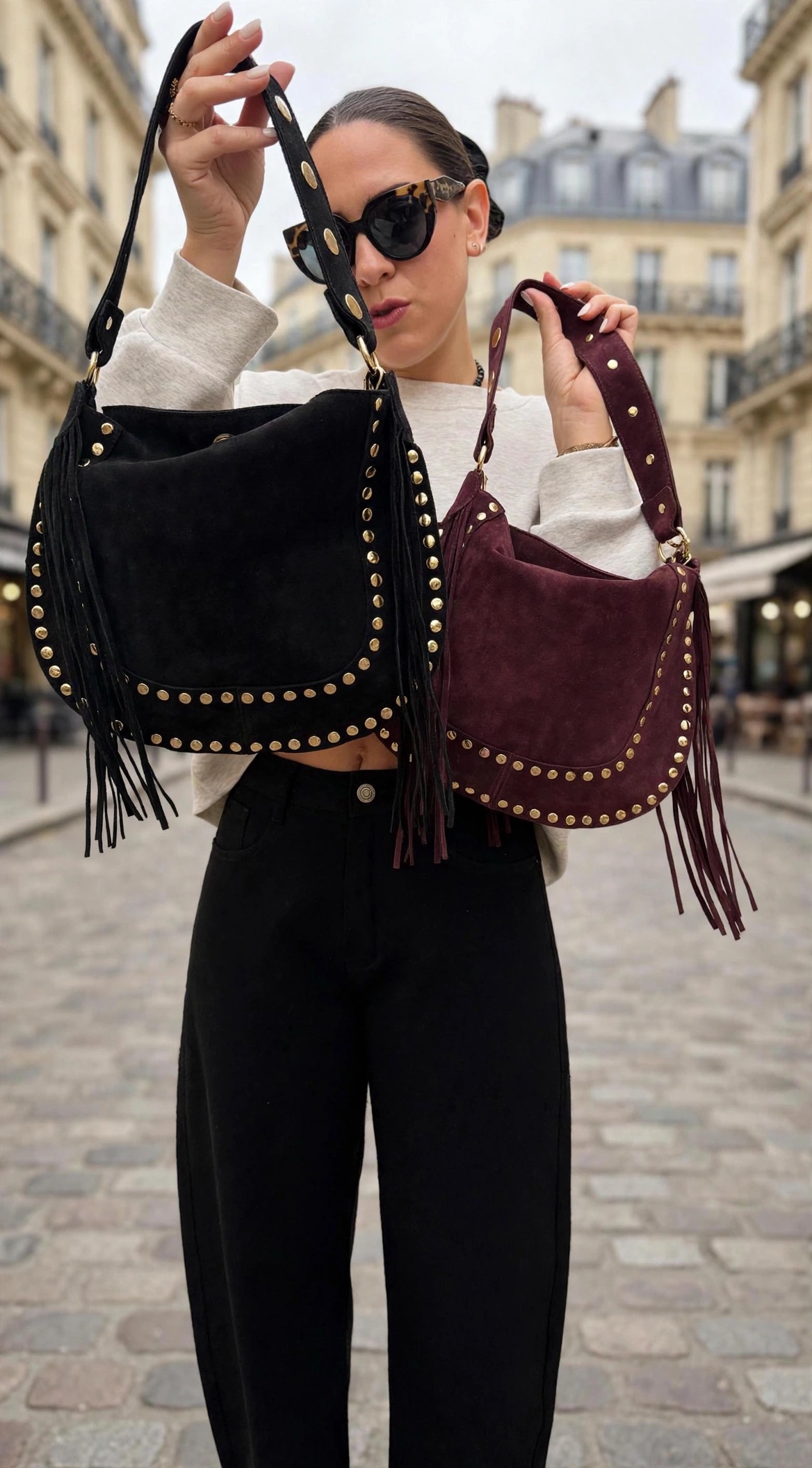Femme portant un sweat bordeaux et un pantalon large en simili cuir bordeaux avec sac à main bordeaux clouté à franges